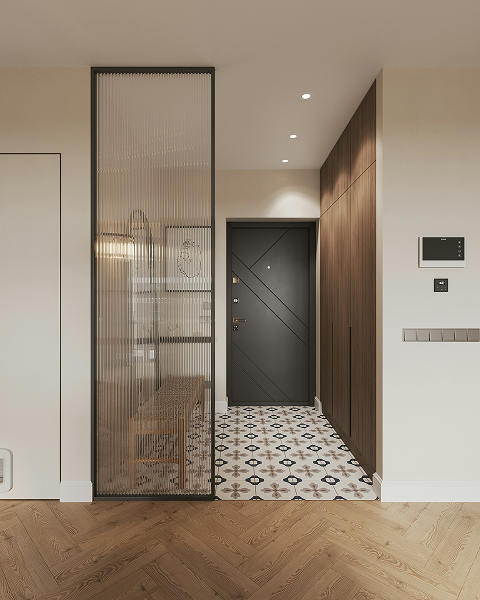 Modern entryway with black door, patterned floor tiles, wooden storage cabinets, and a partition with textured glass.